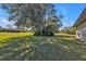 Large, shady front yard with mature tree and lush green lawn at 182 Santarem Cir, Punta Gorda, FL 33983
