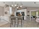 Spacious kitchen featuring white cabinets, black appliances, bar seating, and tile floor at 182 Santarem Cir, Punta Gorda, FL 33983