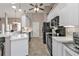 Bright kitchen featuring white cabinets, black appliances, and neutral tile flooring at 182 Santarem Cir, Punta Gorda, FL 33983