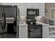 Close up of the black oven and microwave, showcasing the kitchen's cooking appliances at 182 Santarem Cir, Punta Gorda, FL 33983