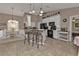 Open kitchen with white cabinets, breakfast bar, black appliances, and tile flooring at 182 Santarem Cir, Punta Gorda, FL 33983