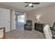 Inviting living room with recliner, neutral paint, and sliding doors to a screened pool area at 182 Santarem Cir, Punta Gorda, FL 33983