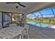 Inviting screened patio featuring comfortable seating and a scenic view of the sparkling pool and backyard at 182 Santarem Cir, Punta Gorda, FL 33983