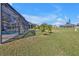 Screened-in pool area with a view of the well-maintained lawn at 182 Santarem Cir, Punta Gorda, FL 33983