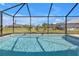 Beautiful in-ground pool with screened enclosure, lush landscaping, and expansive outdoor living space at 182 Santarem Cir, Punta Gorda, FL 33983