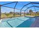 Inviting pool with clear blue water, screened enclosure, and views of the well-maintained backyard and landscape at 182 Santarem Cir, Punta Gorda, FL 33983