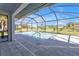 Stunning pool with screened enclosure set against a backdrop of beautifully maintained landscaping and clear blue skies at 182 Santarem Cir, Punta Gorda, FL 33983