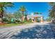 Gated community entrance with palm trees and landscaping at 24512 Bramhope Ct, Port Charlotte, FL 33980