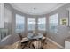 Breakfast nook features a glass-top table and four chairs near windows at 25623 Heritage Lake Blvd. # 57, Punta Gorda, FL 33983