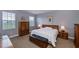 Large main bedroom with a king-size bed and wood furniture at 25623 Heritage Lake Blvd. # 57, Punta Gorda, FL 33983