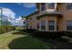Building exterior, showcasing landscaping and tennis courts at 25623 Heritage Lake Blvd. # 57, Punta Gorda, FL 33983