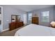 Main bedroom with king bed, dresser, and access to the bathroom at 25623 Heritage Lake Blvd. # 57, Punta Gorda, FL 33983