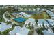 Aerial view showing home location, pool, and tennis courts at 25623 Heritage Lake Blvd. # 57, Punta Gorda, FL 33983