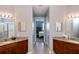 Double vanity bathroom with granite countertop and a shower at 25623 Heritage Lake Blvd. # 57, Punta Gorda, FL 33983