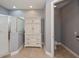 Bathroom with toilet, shower, and white linen cabinet at 25623 Heritage Lake Blvd. # 57, Punta Gorda, FL 33983