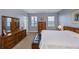 Main bedroom with large bed and wood dresser at 25623 Heritage Lake Blvd. # 57, Punta Gorda, FL 33983