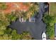Aerial view of a waterfront property with boat dock and lift surrounded by lush greenery at 28522 Coco Palm Dr, Punta Gorda, FL 33982