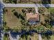 Aerial view of single-story home, pool, and large lot with mature landscaping at 28522 Coco Palm Dr, Punta Gorda, FL 33982