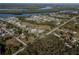 Wide aerial view showing home's location in a residential neighborhood near water at 28522 Coco Palm Dr, Punta Gorda, FL 33982