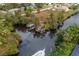Waterfront property featuring a private boat dock and lift, surrounded by canals and foliage at 28522 Coco Palm Dr, Punta Gorda, FL 33982