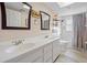 Bathroom with double sinks, tub, and shower at 28522 Coco Palm Dr, Punta Gorda, FL 33982