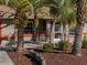 Front view of home showcasing mature palm trees and well-maintained landscaping at 28522 Coco Palm Dr, Punta Gorda, FL 33982