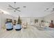 Open living space with hardwood floors, a Christmas tree, and comfortable seating areas at 28522 Coco Palm Dr, Punta Gorda, FL 33982
