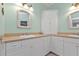 Double vanity bathroom with corner cabinet and light green walls at 3216 Purple Martin Dr # 122, Punta Gorda, FL 33950