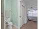 Bathroom with toilet and shower, plus a view into a bedroom at 3216 Purple Martin Dr # 122, Punta Gorda, FL 33950