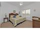 Comfortable bedroom with a king-sized bed and wicker furniture at 3216 Purple Martin Dr # 122, Punta Gorda, FL 33950