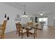 Bright dining room with glass table and wooden chairs, offering a view to the living room at 3216 Purple Martin Dr # 122, Punta Gorda, FL 33950