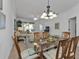 Bright dining room with glass table and wooden chairs, offering a view to the living room at 3216 Purple Martin Dr # 122, Punta Gorda, FL 33950