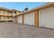 Attached garage with three white doors and brick pavers at 3216 Purple Martin Dr # 122, Punta Gorda, FL 33950