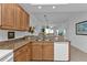 Kitchen with granite counters, wood cabinets, and open layout at 3216 Purple Martin Dr # 122, Punta Gorda, FL 33950