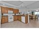 Open kitchen with breakfast bar, granite counters, and wood cabinets at 3216 Purple Martin Dr # 122, Punta Gorda, FL 33950