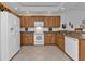 Modern kitchen with white appliances and wood cabinets at 3216 Purple Martin Dr # 122, Punta Gorda, FL 33950