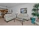 Relaxing living room featuring light-colored sofas and a glass-top coffee table at 3216 Purple Martin Dr # 122, Punta Gorda, FL 33950