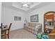 Cozy office space featuring a sofa, desk, and built-in shelving at 3216 Purple Martin Dr # 122, Punta Gorda, FL 33950