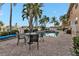 Community pool area with patio seating and umbrella at 3216 Purple Martin Dr # 122, Punta Gorda, FL 33950
