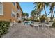Community pool with patio furniture and lush landscaping at 3216 Purple Martin Dr # 122, Punta Gorda, FL 33950