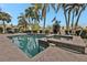 Community pool and spa with brick pavers and palm trees at 3216 Purple Martin Dr # 122, Punta Gorda, FL 33950