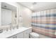 Bathroom with single vanity, toilet, and shower with striped curtain at 433 Cerromar Ln # 441, Venice, FL 34293