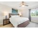 Main bedroom with king-size bed, nightstands, and a large window at 433 Cerromar Ln # 441, Venice, FL 34293