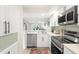 Updated kitchen boasting stainless steel appliances and white cabinetry at 433 Cerromar Ln # 441, Venice, FL 34293
