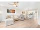 Open living area with L-shaped sofa and view of kitchen and dining area at 433 Cerromar Ln # 441, Venice, FL 34293