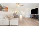 Spacious living room featuring an L-shaped sofa, recliner, and large TV at 433 Cerromar Ln # 441, Venice, FL 34293