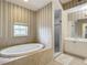 Bathroom with soaking tub, walk-in shower, and double vanity at 5115 Melbourne St # A206, Punta Gorda, FL 33980