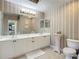 Double vanity bathroom with a toilet and decorative accents at 5115 Melbourne St # A206, Punta Gorda, FL 33980