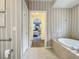 Bathroom with a view into a bedroom and a tub at 5115 Melbourne St # A206, Punta Gorda, FL 33980