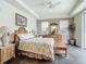 Primary bedroom with king bed, dark wood floors, and access to balcony at 5115 Melbourne St # A206, Punta Gorda, FL 33980